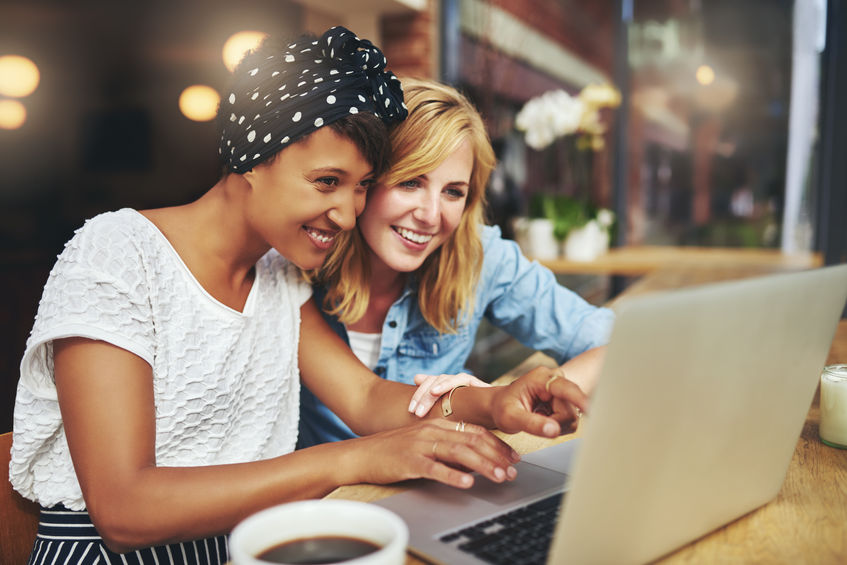 two women looking at computer